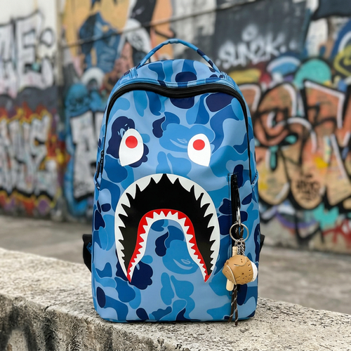 Zaino Shark Camo Blu frontale su muretto con graffiti, immagine generata